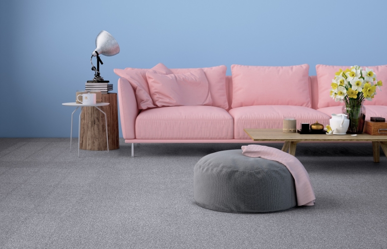 Grey carpet with pink sofa and blue walls